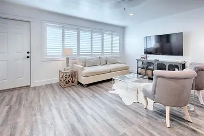 a living room with a couch and a tv at Suite Y'all in Santa Rosa Beach