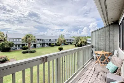 a balcony with a view of a building at Suite Y'all in Santa Rosa Beach