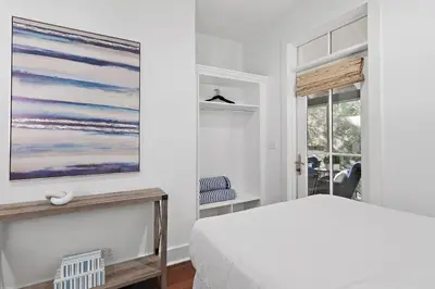 a bedroom with a bed and a painting on the wall at The Magnolia Mermaid in Panama City Beach