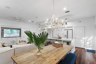 a living room with a table and a couch at The Magnolia Mermaid in Panama City Beach