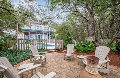a patio with chairs and a fire hydrant in front of a house at Ten Grand in Santa Rosa Beach