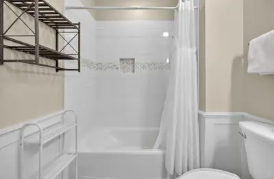 a white bathroom with a shower and a toilet at Tennessee by the Sea in Inlet Beach