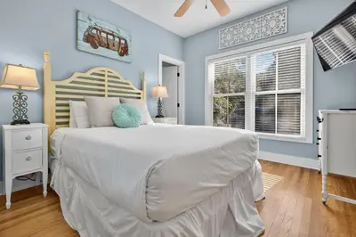 a bedroom with a large bed and a window at Tennessee by the Sea in Inlet Beach
