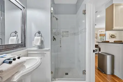 a white bathroom with a shower and a sink at Tennessee by the Sea in Inlet Beach
