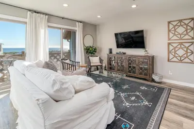a living room with a white couch and a tv at Wonderful World in Inlet Beach