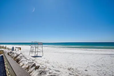 a beach with a life guard stand on the sand at Wonderful World in Inlet Beach