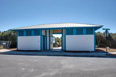 a blue and white building with two white garage doors at Wonderful World in Inlet Beach