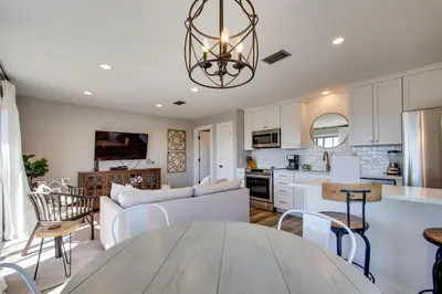 a kitchen and a living room with a table at Wonderful World in Inlet Beach
