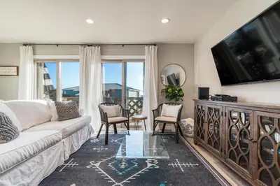 a living room with a couch and a flat screen tv at Wonderful World in Inlet Beach