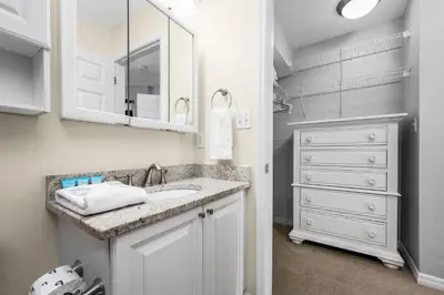 a bathroom with a sink and a mirror at Rollin Tides in Santa Rosa Beach