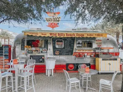 a food truck with tables and chairs in front of it at Rollin Tides in Santa Rosa Beach