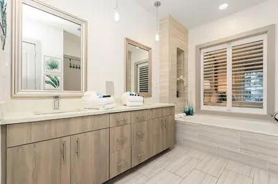 a bathroom with a tub and a sink and a shower at Shore Beats Workin' in Inlet Beach