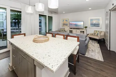 a kitchen and living room with a table and chairs at Shore Beats Workin' in Inlet Beach