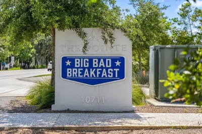 a sign for a big bad breakfast on a street at Shore Beats Workin' in Inlet Beach