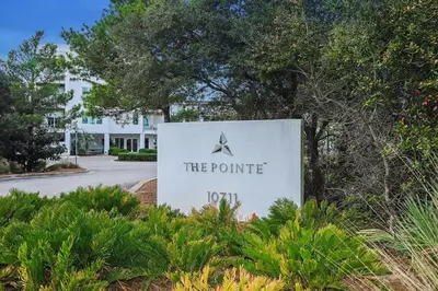 a sign for the pointe hotel in front of a building at Shore Beats Workin' in Inlet Beach