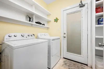 a laundry room with a washer and dryer at Grand Tortuga Crush in Panama City Beach