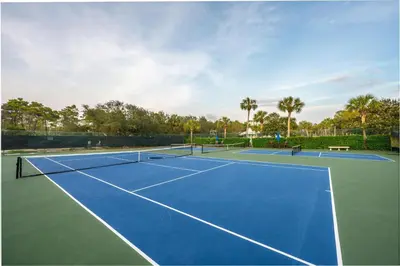 a tennis court with two tennis courts at Grand Tortuga Crush in Panama City Beach