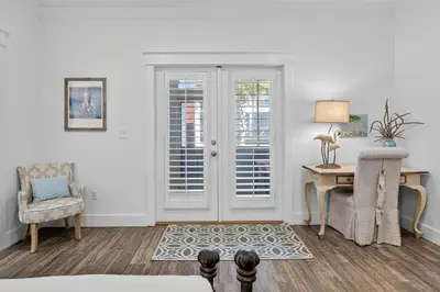 a room with a desk and a chair and a door at Cute as a Button in Inlet Beach