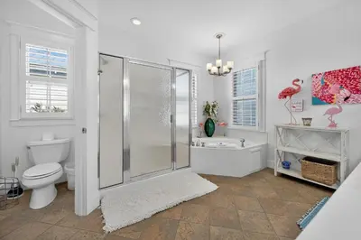 a bathroom with a shower and a toilet and a sink at Cute as a Button in Inlet Beach