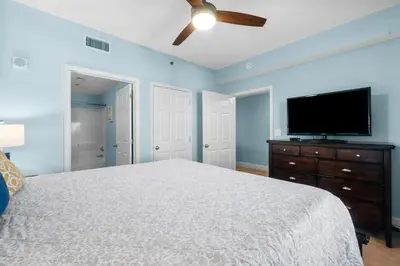 a bedroom with a bed and a flat screen tv at Laketown Wharf #1818 in Panama City Beach