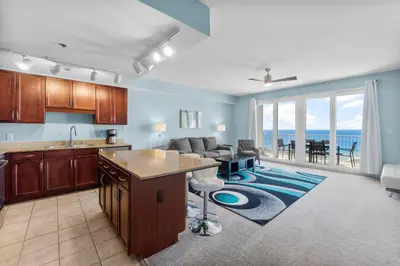 a kitchen and living room with a view of the ocean at Laketown Wharf #1818 in Panama City Beach
