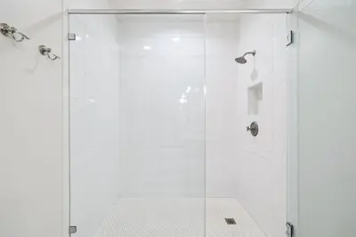 a white shower with a glass door at Summer Breeze by 30A Escapes in Rosemary Beach