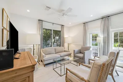 a living room filled with furniture and a flat screen tv at Summer Breeze by 30A Escapes in Rosemary Beach