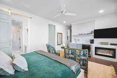 a bedroom with a bed and a fireplace at The Sand Castle by 30A Escapes in Panama City Beach