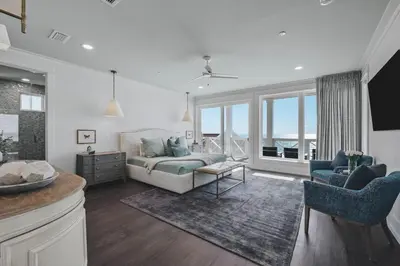 a living room with a bed and a couch at The Sand Castle by 30A Escapes in Panama City Beach