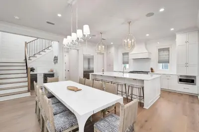 a white kitchen with a white table and chairs at Paralia 30A in Seagrove Beach