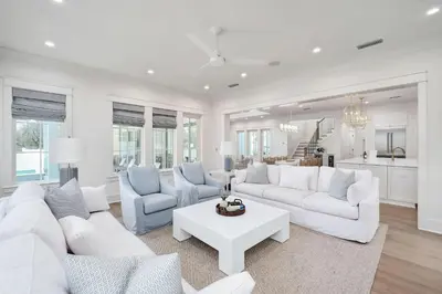 a living room with white furniture and a white table at Paralia 30A in Seagrove Beach