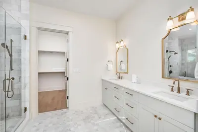 a white bathroom with a sink and a shower at Paralia 30A in Seagrove Beach