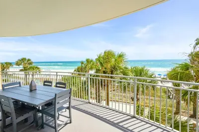 a balcony with a table and a view of the ocean at Aqua 203 in Panama City Beach