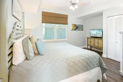 a bedroom with a bed and a window at Aqua 203 in Panama City Beach