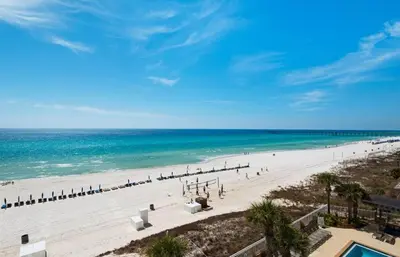an overhead view of a beach with chairs and the ocean at Aqua 203 in Panama City Beach