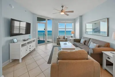 a living room with a couch and a tv at Aqua 410 in Panama City Beach