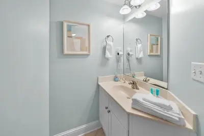 a bathroom with a sink and a mirror at Aqua 410 in Panama City Beach