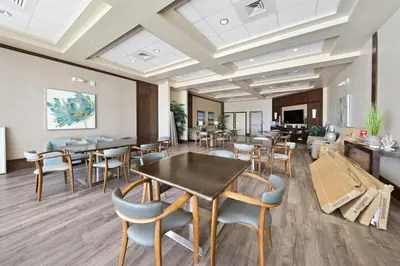 a waiting room with tables and chairs in a building at Aqua 410 in Panama City Beach