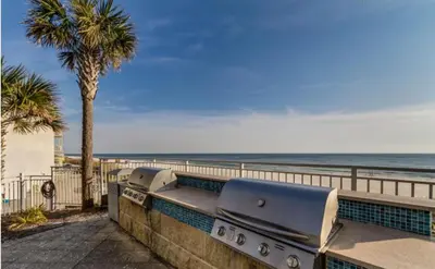 a bench overlooking the beach and the ocean at Aqua 410 in Panama City Beach