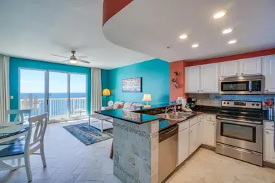 a kitchen with a view of a living room at Calypso 2107W in Panama City Beach