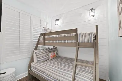 a childs bunk bed in a room with white walls at Aqua 603 in Panama City Beach