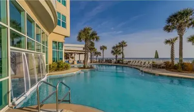 a swimming pool with a view of the ocean at Aqua 603 in Panama City Beach