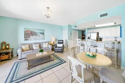 a living room with a couch and a table at Calypso 803W in Panama City Beach