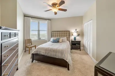 a bedroom with a bed and a ceiling fan at 609 Aqua in Panama City Beach