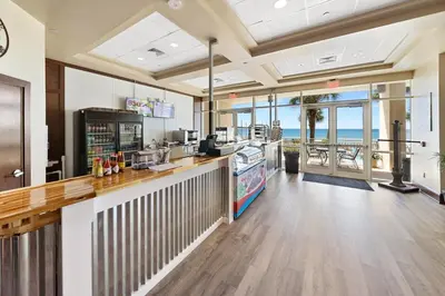 a restaurant with a counter with a view of the ocean at 609 Aqua in Panama City Beach