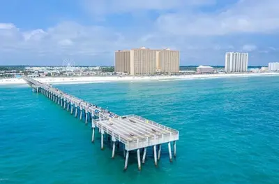 a pier in the middle of the ocean with a beach at 609 Aqua in Panama City Beach