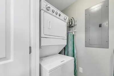 a small white kitchen with a white stove top oven at Sterling Breeze 1903 in Panama City Beach