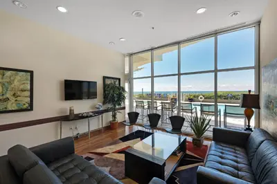 a living room with a couch and a table at Sterling Breeze 1903 in Panama City Beach