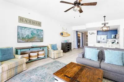 a living room with a couch and a table at Aqua 705 in Panama City Beach