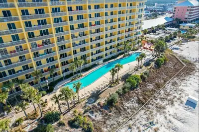 an aerial view of a resort with a pool and palm trees at Calypso 908W Stunning condo, beach front, and immaculate in Panama City Beach